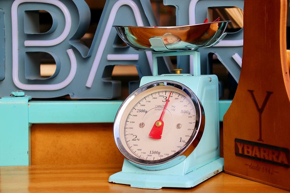 A vintage kitchen scale with fruit