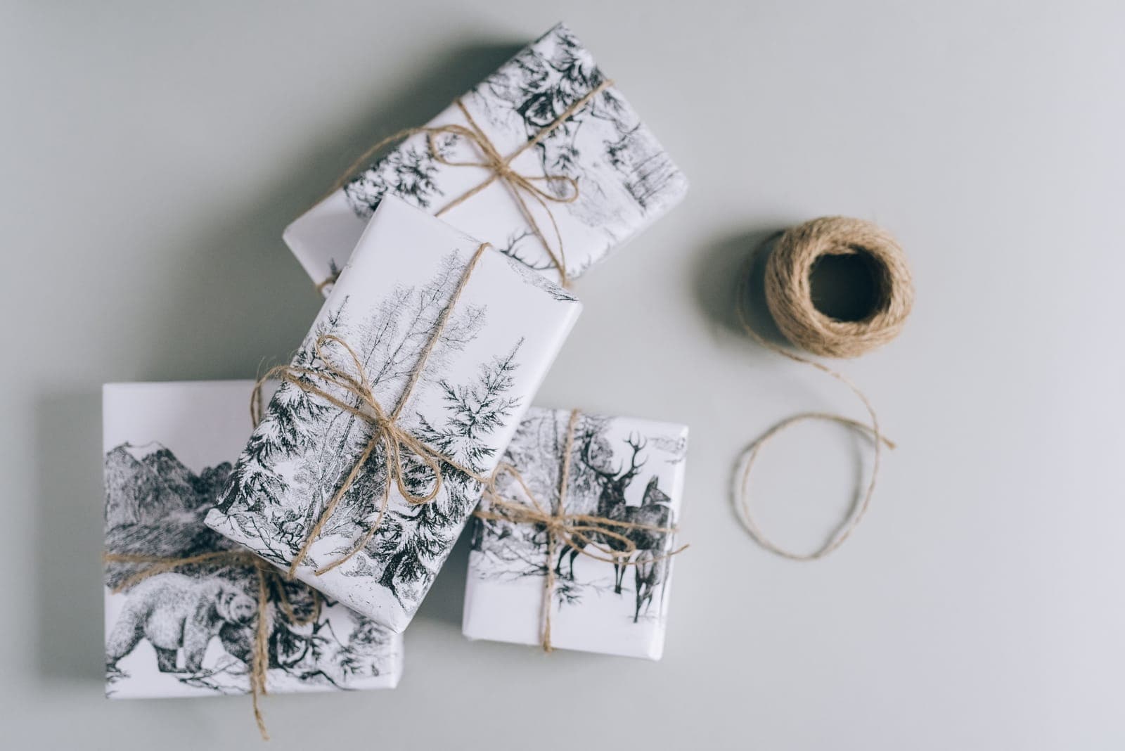 Gift boxes wrapped in nature-print paper and tied with twine